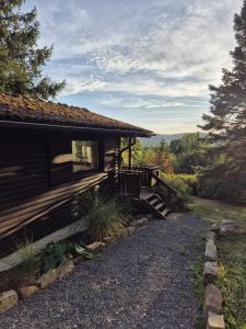 a log cabin with a porch and stairs to it at Ferienhaus Bärenloch in Hilders
