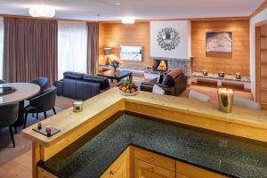a living room with a couch and a table at Chalet RoyAlp Hôtel & Spa in Villars-sur-Ollon