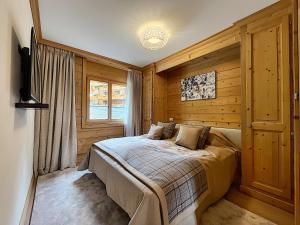 a bedroom with a bed in a room with wooden walls at Chalet RoyAlp Hôtel & Spa in Villars-sur-Ollon +114 photos