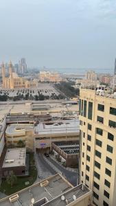 an overhead view of a city with buildings and roads at Apartment suite in Manama