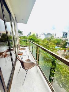 2 stoelen op een balkon met uitzicht op de stad bij Bellooceano in Playa del Carmen +17 foto's