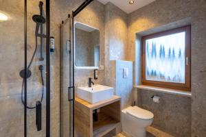 a bathroom with a sink and a toilet and a shower at MyLiving - Hotel B&B in San Lorenzo di Sebato