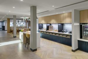 a large kitchen with blue cabinets and a counter at TownePlace Suites by Marriott Miramar Beach Destin in Destin