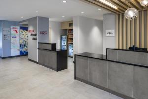 a lobby with two reception desks in a building at TownePlace Suites by Marriott Miramar Beach Destin in Destin +43 photos