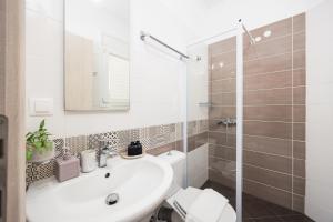 a bathroom with a sink and a toilet and a shower at Villa Alya View in Barbati +14 photos