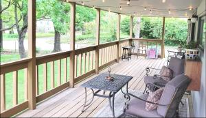 a screened in porch with a table and chairs at The Great Escape, Black Mountain in Black Mountain