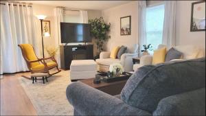 a living room with a couch and a tv at The Great Escape, Black Mountain in Black Mountain