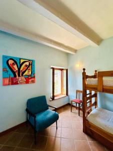 a bedroom with a chair and a bunk bed at Agribirrificio Corte Petacchi in Volta Mantovana +3 photos