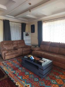 a living room with a couch and a coffee table at Kukis Place, 5 bedrooms, whole compound in Embu