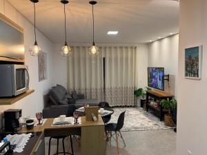 un soggiorno con un divano e un tavolo di Casa Nova & Aconchegante a São Bento do Sul