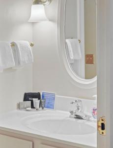 a bathroom with a white sink and a mirror at 109 Water Street Inn in Boyne City +26 photos