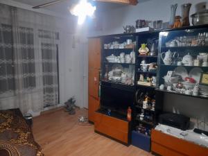a room with a shelf with cups and dishes at zafira in Varna City