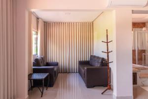 ein Wohnzimmer mit zwei Sofas und einem Tisch in der Unterkunft Pousada Dona Bili in Pirenópolis