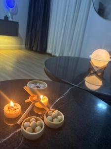 een glazen tafel met eieren en kaarsen erop bij Sweet Dream Apartment in Lekki