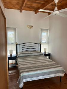 un letto in una stanza con due tavoli e un ventilatore a soffitto di Bajada 1-2 a Las Grutas