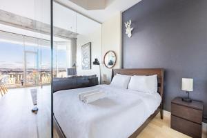 een slaapkamer met een groot bed met een groot raam bij Les Immeubles Charlevoix - Le 760-108 in Québec