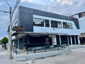 a building with a sign on the side of a street at GM Suites in Cúcuta