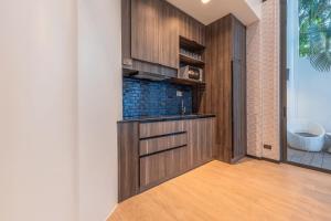 een kamer met een keuken met houten kasten bij Maya Luxury Pool Villa Inara in Pattaya South