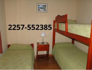 En eller flere senge i et værelse på Duplex Quimey