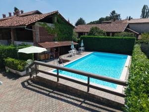 a swimming pool in the backyard of a house at La Cascina in Agliè