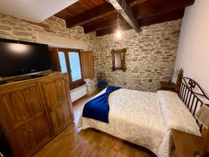 Ένα ή περισσότερα κρεβάτια σε δωμάτιο στο Casa Rural Bango