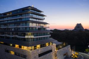 a rendering of a building with two towers in the background at Espacio Nagoya Castle, The Leading Hotels of the World "LHW" in Nagoya +220 photos