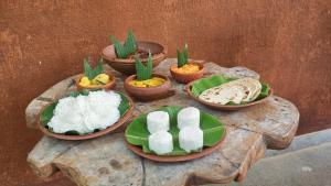 a table with plates of food and bowls of rice at Hotel Oleena in Habarana