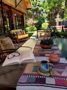 a table with an open book and a cup of coffee and a book at Casa Emiluz in La Serena