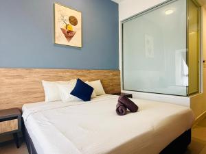 a bedroom with a bed with a teddy bear sitting on it at Imperio Residence with Private Bathtub by Lets Stay in Malacca +242 photos