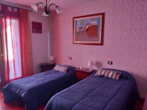 Ένα ή περισσότερα κρεβάτια σε δωμάτιο στο La tua casa meravigliosa con giardino