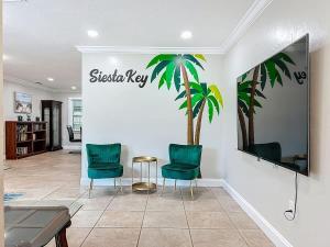 een lobby met 2 groene stoelen en een tafel bij Siesta Key Paradise for Beach Lovers in Southgate