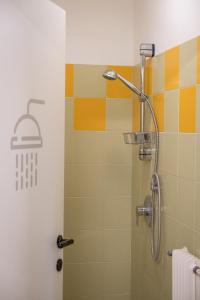 a bathroom with a shower with a basket on the wall at Campeggio Treinke Sauris in Sauris +59 photos