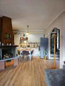 a kitchen with a table and a refrigerator at Dimora Paradise in Laglio