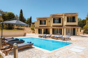a villa with a swimming pool and a house at Elite Villa Dio in Áno Korakiána