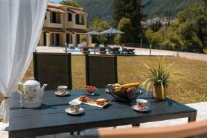 a black table with cups and food on it at Elite Villa Dio in Áno Korakiána
