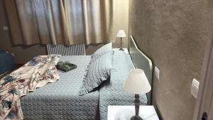 a small bedroom with a bed and a lamp at Podere Gorette in Poggibonsi