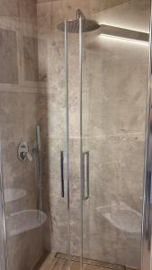 a shower with a glass door in a bathroom at Podere Gorette in Poggibonsi