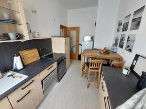 a kitchen with a table and a dining room at Monteurs- und Mietwohnung - Wohlfühlen am Tagesende in Eilenburg