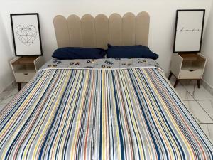 a bedroom with a large bed with two night stands at Casa próximo à rodoviária e centro in Rondonópolis