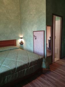 a bedroom with a bed and a mirror and a door at TABERNA ROMANA VILLA OCA b&b in Velletri