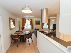 a kitchen and living room with a table and chairs at 32A Bank Street in Rossendale