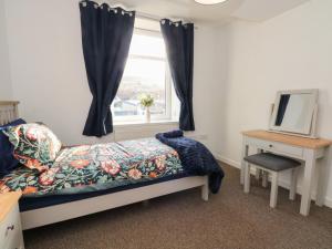 a bedroom with a bed and a window at 32A Bank Street in Rossendale