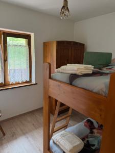 Dolomiti Dream House في سنسنيجا: غرفة نوم مع سرير بطابقين ونافذة +14 صورة