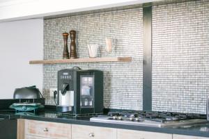 a kitchen with a coffee maker on a counter at MY Tropézienne in Saint-Tropez