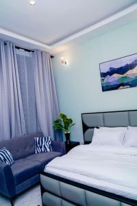 En eller flere senge i et værelse på Giovanna Executive Lodge