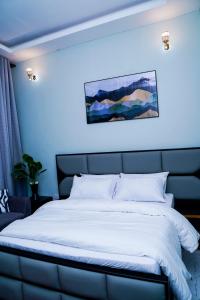 En eller flere senge i et værelse på Giovanna Executive Lodge