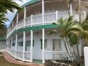 a large white building with a balcony at Queen Deluxe Double at Boundless Bliss Hotel in Raphune +20 photos