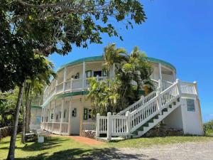 a large building with a staircase in front of it at Queen Deluxe Double at Boundless Bliss Hotel in Raphune