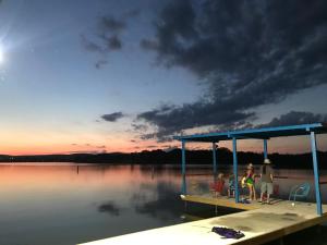 a group of people standing on a dock on a lake at Valentine Lakeside in Kingsland +95 photos