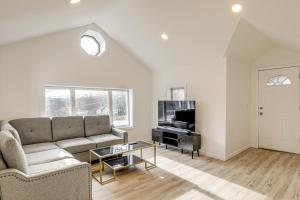 a living room with a couch and a tv at Home with Lake Views and Deck in New Jersey Highlands! in Stanhope